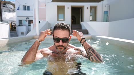 a-hot-guy-in-slow-motion-at-the-edge-of-the-pool-in-santorini