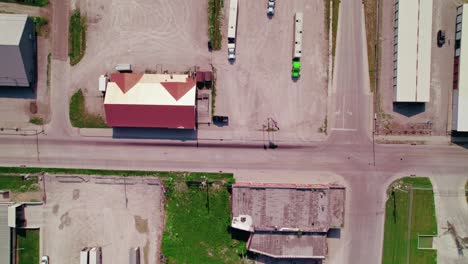 Top-down-three-livestock-trailers-with-trucks-parked-in-an-industrial-parking-lot