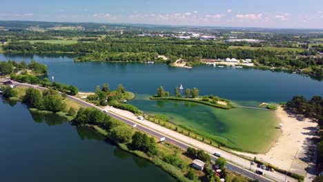 Na-Piaskach-Reservoir,-scenic-lakeside-views,-a-road,-and-sandy-beaches,-Budzyn,-Poland