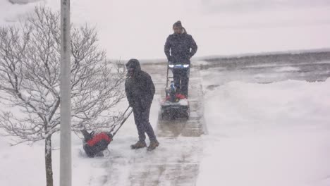 Menschen-Räumen-Verschneite-Straßen-Mit-Schneefräsen-Und-Schaffen-So-Sichere,-Befahrbare-Wege