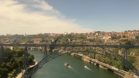 Point-of-view-shot-from-the-train-of-the-double-deck-metal-arch-Dom-Luís-I-Bridge-and-scenic-Douro-River-approaching-Porto,-Portugal