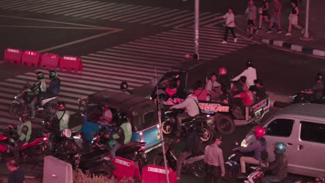 Nighttime-traffic-jam-with-motorcycles-and-vehicles-at-a-busy-intersection-in-Jakarta-City