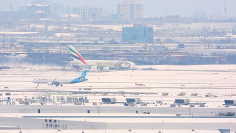 Aircrafts-maneuvering-slowly-on-a-snow-covered-tarmac,-set-against-a-backdrop-of-serene-winter-scene-at-airport