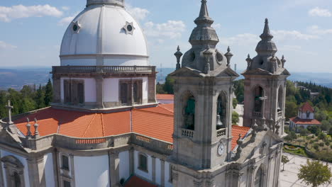 Aerial-of-old-catholic-church-bells-and-cross,-Portugal,-close-up