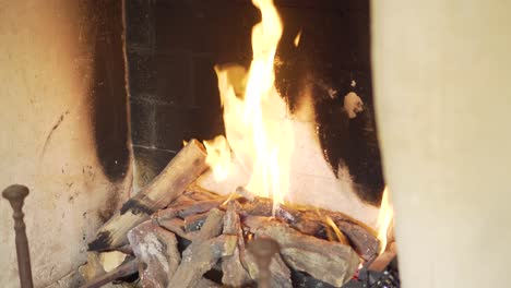 Upward-tilting-view-of-traditional-style-cosy-home-fireplace-burning