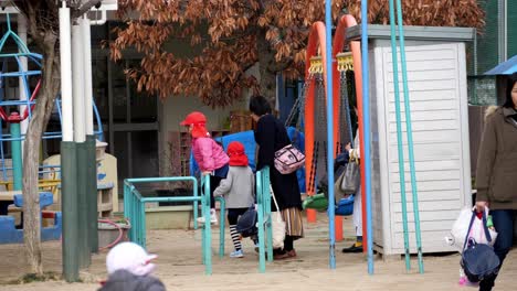 School-kids-playing-in-court-and-swing