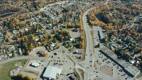 A-cinematic,-panning,-aerial-view-of-a-small-city-during-the-autumn-season