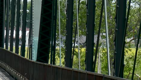 Close-up-of-old-pedestrian-bridge-over-river