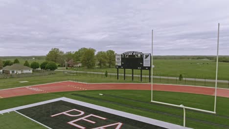 Pea-Ridge,-Arkansas-low-altitude-aerial-of-football-field-goal-post-and-scoreboard