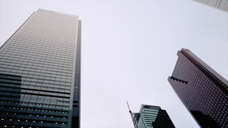 Modernos-Edificios-De-Gran-Altura-Contra-El-Cielo-Gris-En-Toronto,-Ontario,-Canadá---Tiro-Circular-En-ángulo-Bajo