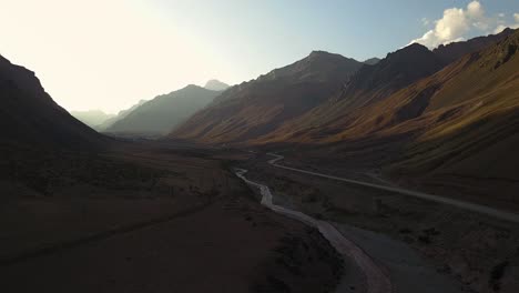 Panoramic-view-of-trucks-traveling-the-route-between-the-mountains-in-Los-Andes,-Argentina