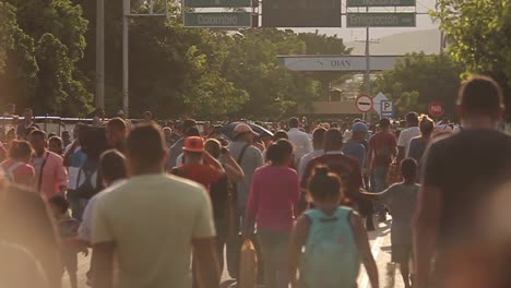 Slow-motion-shot-of-migrants-walking-to-Simon-Bolivar-International-Bridge,-which-connects-Colombia-and-Venezuela