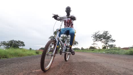 Happy-young-black-kid-riding-a-bicycle-slow-motion