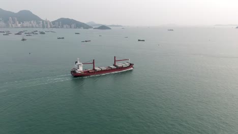 Mega-Container-Ship-leaving-Hong-Kong-port,-Aerial-view