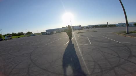 Stunt-biker-does-a-wheelie-trick,-filmed-with-an-FPV-drone