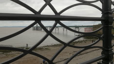 A-View-of-the-Clevedon-Victorian-Beach-Pier-Looking-Through-the-Railings-on-a-Cloudy-Overcast-Day