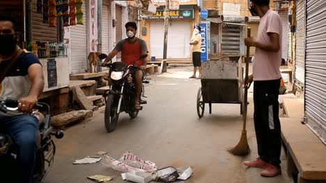 cleaning-worker-sweeping-streets-wearing-mask-in-the-COVID-19-crisis-lockdown