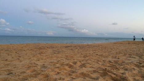 Family-walking-on-sand-beach-at-sunset-dynamic-motion-timelapse