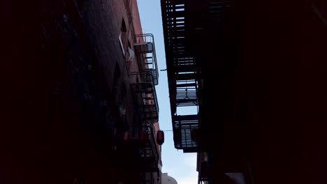 Walking-in-Alley-With-Red-Brick-Buildings-in-Chinatown