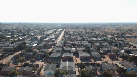 A-Pull-Back-Drone-Shot-of-Township-Housing-Complex-Under-Sunny-Conditions