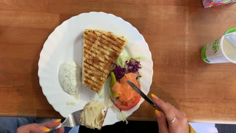 Female-hands-with-bright-colorful-nail-polish-is-cutting-water-borek