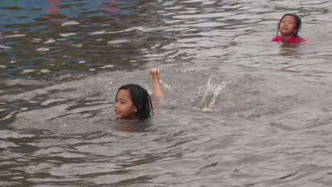 Small-children-playing-in-the-streets-submerged-by-flood-water