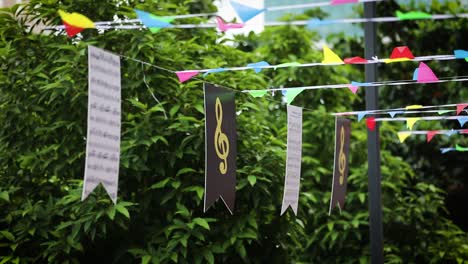 Colorful-small-flags-and-music-symbols-hanging-on-street