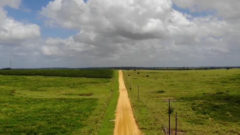 Aerial-Shot-of-old-dirt-road-beside-the-lake