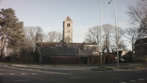 Velsen-Zuid-Netherlands---January-22nd-2019:-still-shot-of-street-view-of-Engelmunduskerk-Oud-Velsen-church-in-a-neighborhood-during-winter-with-sunset-sunlight