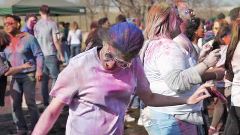 Colorful-girl-dancing-at-Holi-festival,-Slow-motion