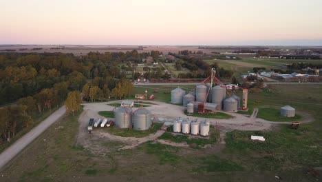 Aerial-shot-of-some-agricultural-silos-at-nightfall