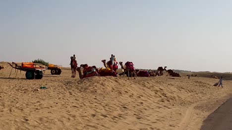 Beautiful-landscape-of-arid-land-of-Sam-sand-dunes-in-Thar-desert,-Rajasthan,-India-showing-tourist-enjoying-camel-safari