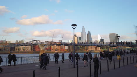 Crowd-of-people-walking-past-Saint-Paul-Cathedral-and-Millenium-Bridge,-panning-right-to-Leadenhall-and-Fenchurch-modern-buildings-skyline,-on-the-first-day-after-Brexit