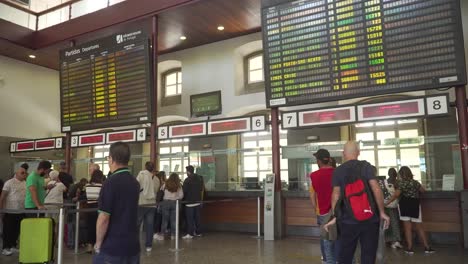 People-in-line-waiting-to-buy-train-tickets-inside-Capamnhã-train-station-in-Porto,-Portugal