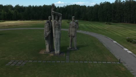 Aerial-shot-of-a-three-group-of-statues-in-the-Salaspils-Memorial,-Latvia