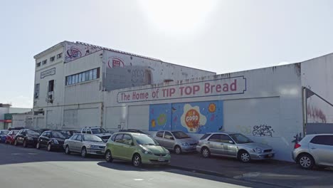 A-stationary-shot-looking-up-at-the-abandoned-Tip-Top-Bread-Factory-in-Wellington,-NZ