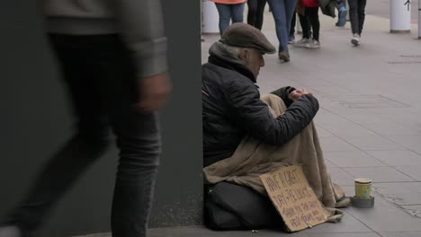 Sad-looking-homeless-man-in-London-gets-given-money-and-looks-up-to-appreciate-the-man-who-has-given-him-money