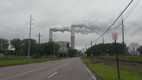 Coal-fired-electrical-plant,-steam,-smoke,-pollution-rising-from-twin-stacks,-power-generation,-clean-coal