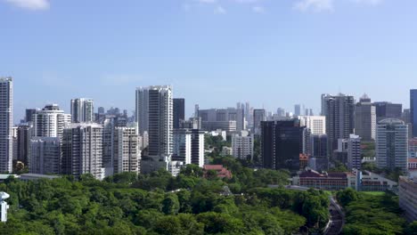 view-of-Balestier-and-Novena-skyline,-highway-and-National-Park-,-luxuriant-vegetation-and-traffic