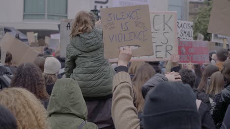 Crowd-of-protester-protesting-and-holding-signs-against-racism-while-cheering-and-raising-fists-at-a-black-lives-matter-protest-in-Stuttgart,-Germany