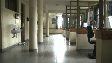 doctor-cleaning-up-in-a-long-hallway-in-an-eye-hospital-in-Rwanda,-Africa