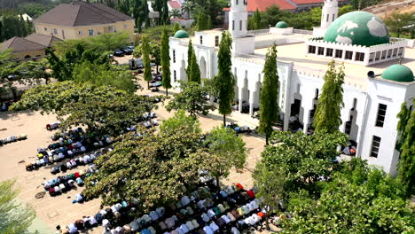 Hundreds-of-people-pray-with-the-Mosque-full-and-the-courtyard-also-full-for-Friday-prayers---static-aerial-view