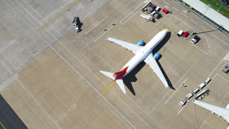 Tracking-shot-of-a-Sunwing-airplane-taxiing-to-its-arrival-terminal-gate