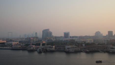 This-is-an-aerial-view-of-the-Dubai-skyline-and-Old-Dubai,-with-Burj-Khalifa-and-Dubai-Frame-appearing-in-the-horizon