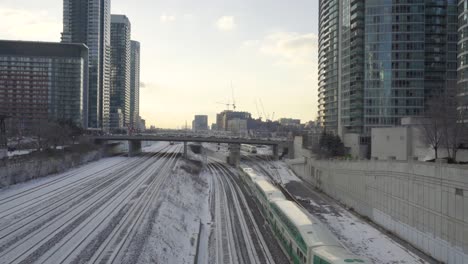 Downtown-Toronto,-A-Go-Train-Leaves-The-City-During-Winter