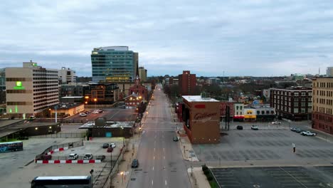 Aerial-view-low-over-a-street,-in-cloudy-Columbus,-Ohio,-USA---reverse,-drone-shot