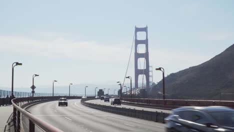 Fast-Moving-Traffic-Moving-Through-Golden-Gate-Bridge-on-a-Sunny-Day-in-San-Francisco,-California