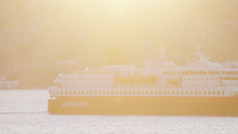 Bright-Sun-At-Sunrise-Shining-Over-The-Hurtigruten-Boat-Sailing-In-The-Coast-Of-Norway