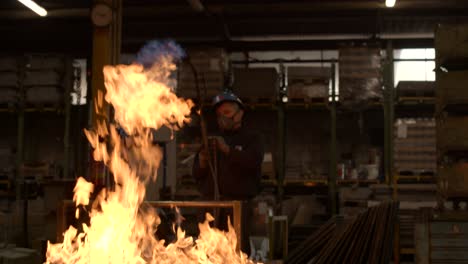 Worker-with-a-flamethrower-working-on-a-refractory-mold