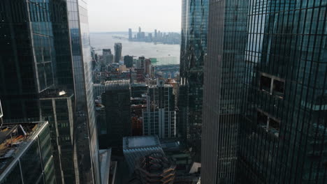 Drone-shot-flying-between-high-rise-in-Hudson-Yards,-sunny-day-in-New-York,-USA